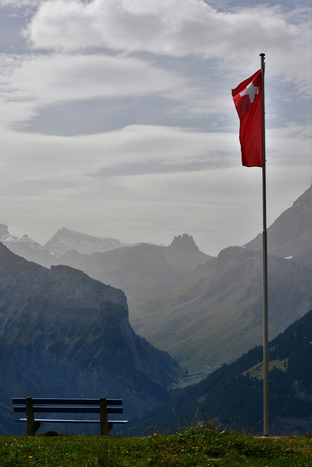 red flag on pole on top of the mountain