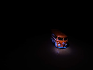 A sturdy cargo van body in a bright orange and dark gray palette.