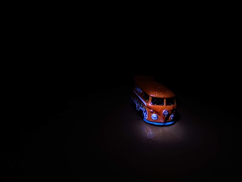 A sturdy cargo van body in a bright orange and dark gray palette.