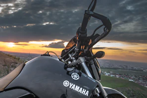 Sunset view with a Yamaha motorcycle silhouette against the vibrant Guaviare landscape