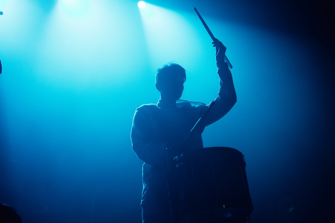 man in white dress shirt playing guitar, Concert Drummer