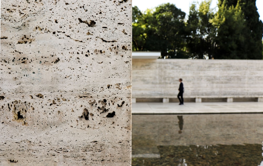 man in black jacket walking on gray concrete road during daytime