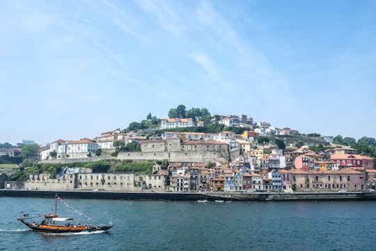 boat on water near city buildings during daytime in Vila Nova de Gaia Portugal