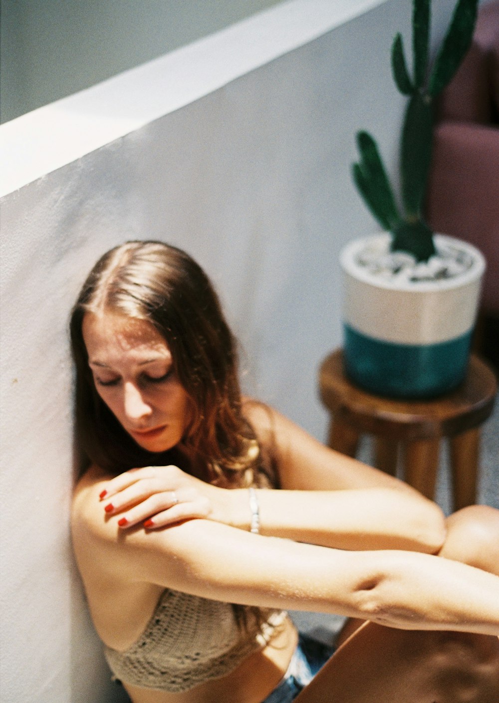 woman in white tank top sitting on chair