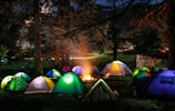 A cozy campsite with a glowing campfire and tents.