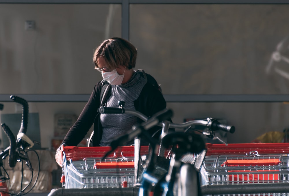 woman in black jacket riding on red and black motorcycle