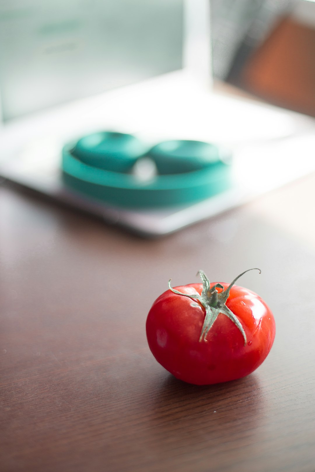 red tomato on brown table