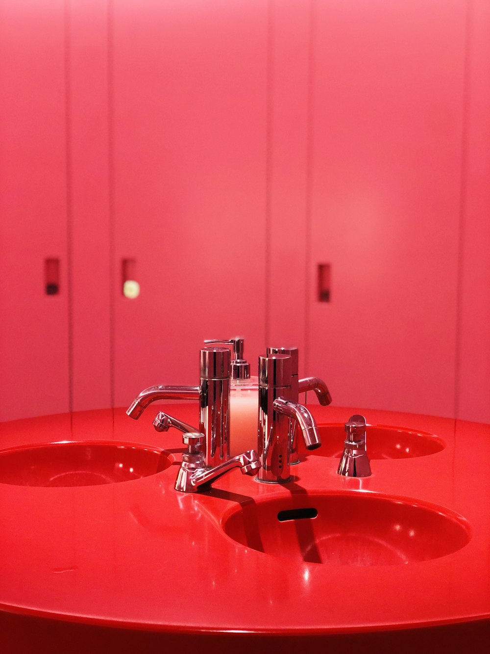 red ceramic sink with stainless steel faucet