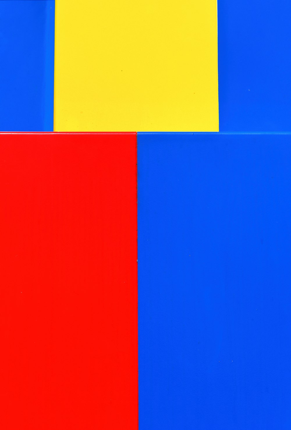 a red, yellow, and blue painting with a white background