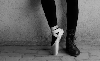 person wearing black and white high top sneakers