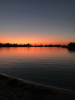 Sunset view over the tranquil lake reflecting the vibrant sky colors