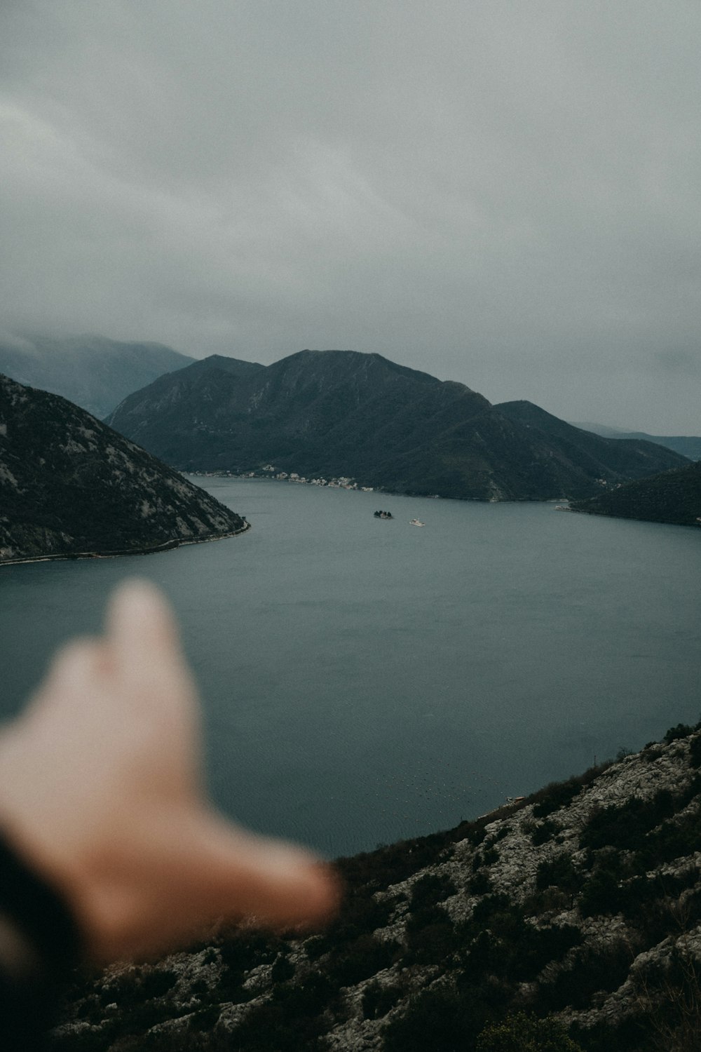 body of water near mountain during daytime