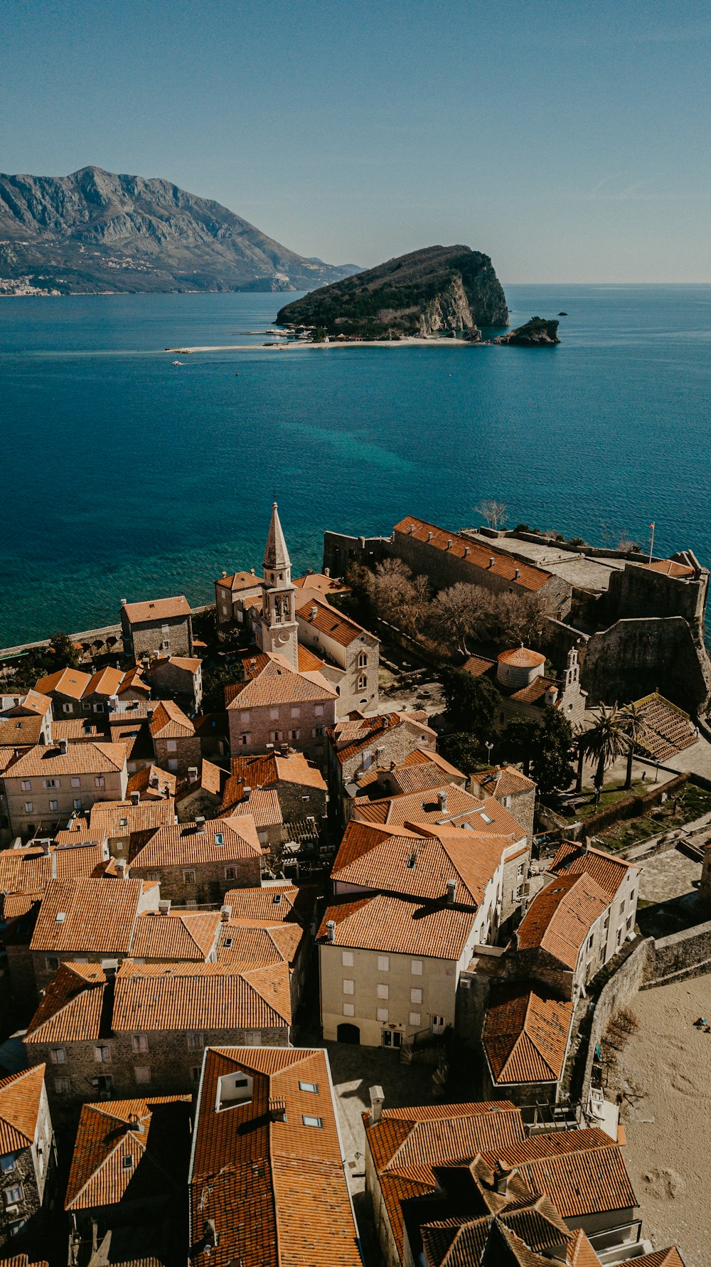 brown concrete houses near sea during daytime