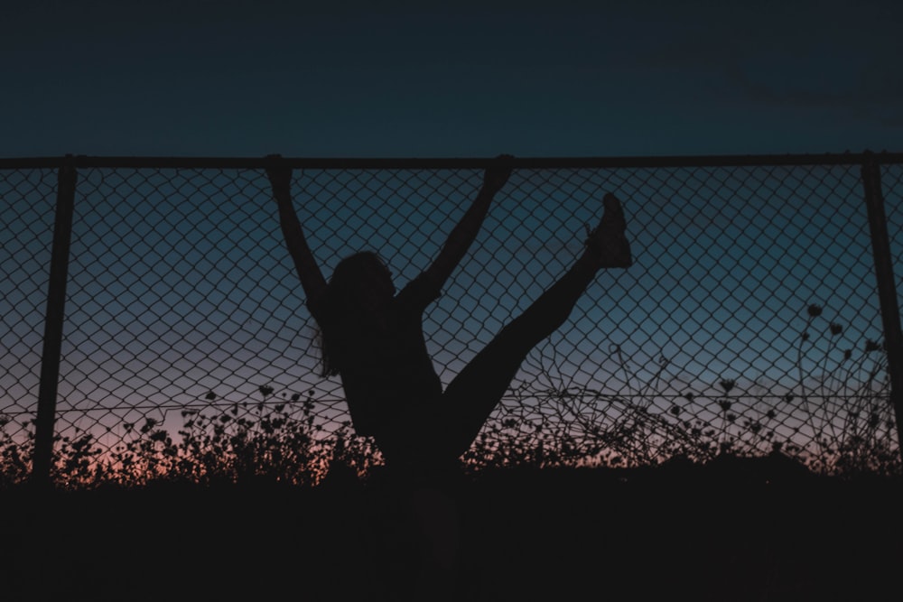 silhouette of woman jumping on trampoline