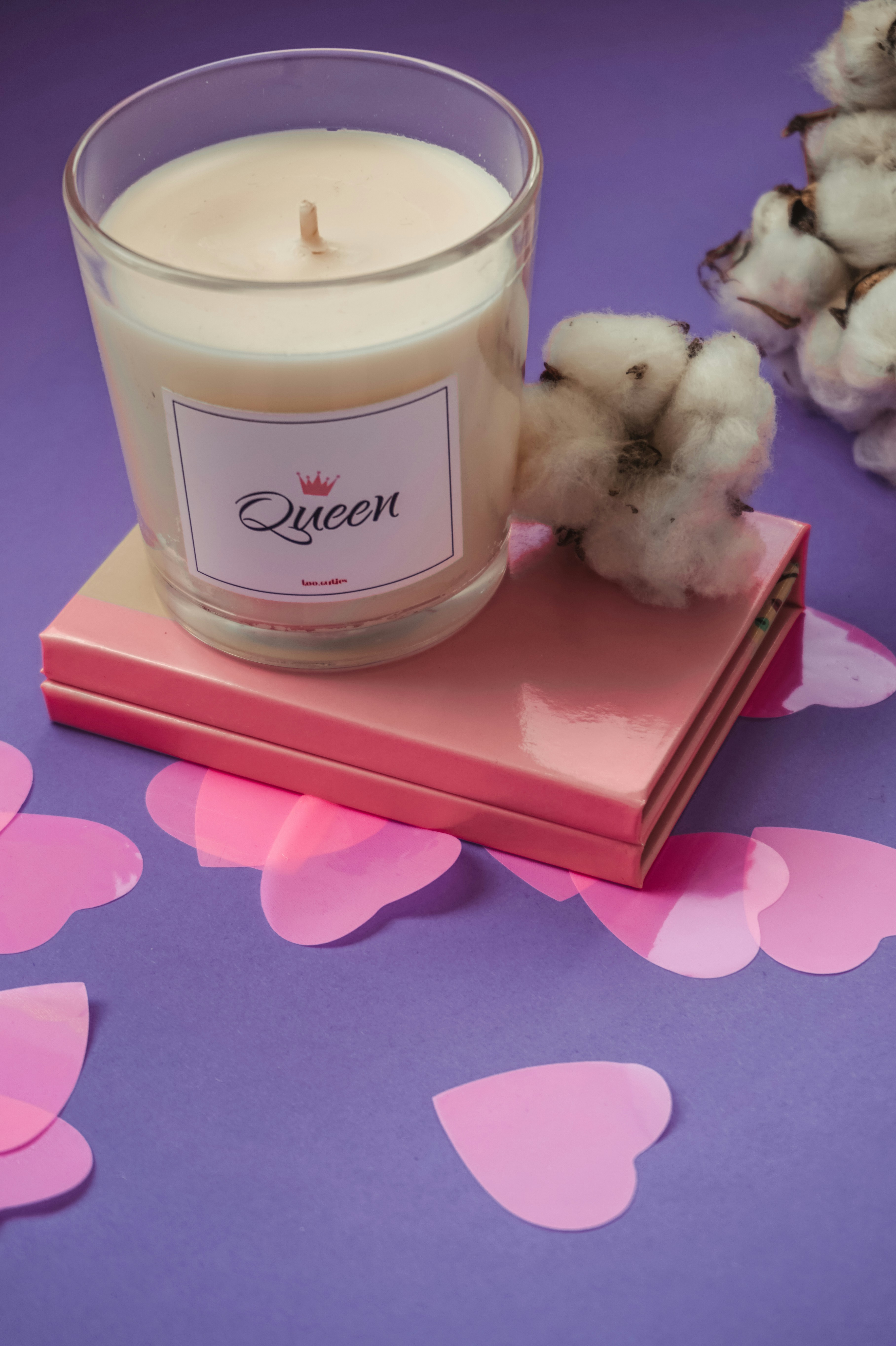 White pillar candle on red box photo Free Milk Image on Unsplash