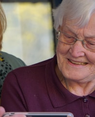 woman in purple polo shirt wearing eyeglasses