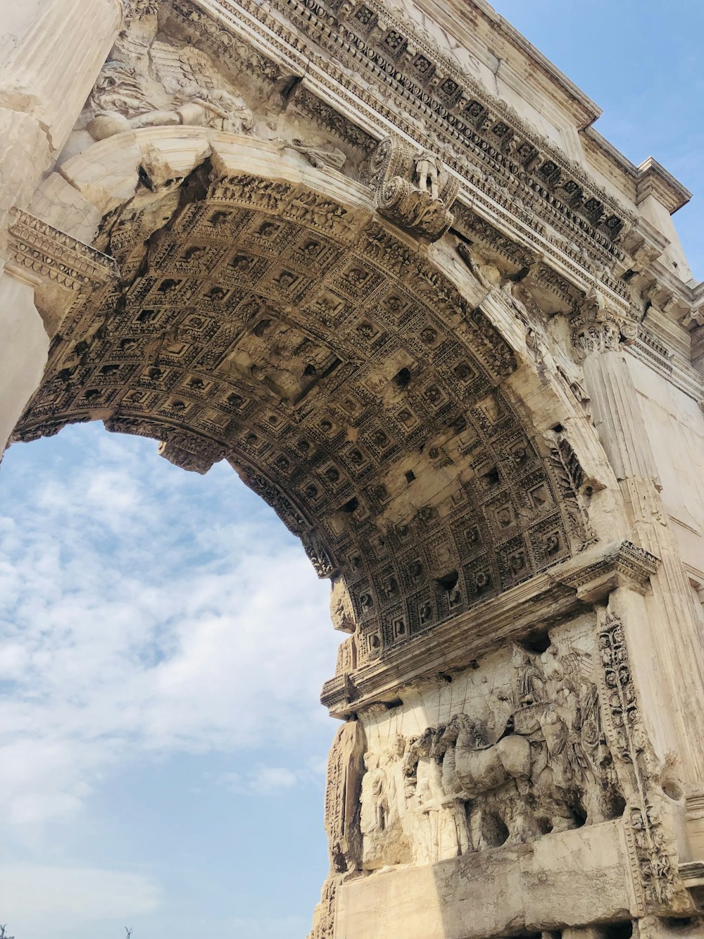 arche en béton brun sous le ciel bleu pendant la journée