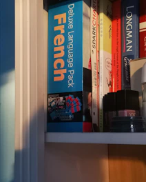 black and gray electronic device on white wooden shelf