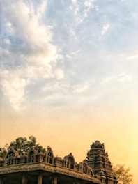 A serene view of Shri Bhuteshwar Mahadev Mandir at sunset, with intricate stone carvings glowing warmly.