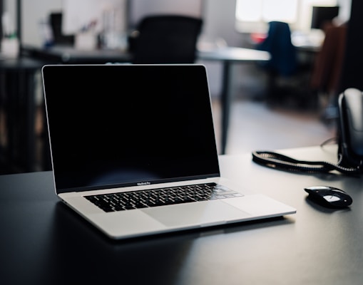 macbook pro on white table