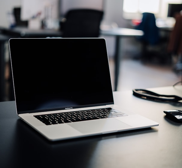 macbook pro on white table