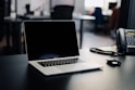 macbook pro on white table