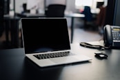 macbook pro on white table
