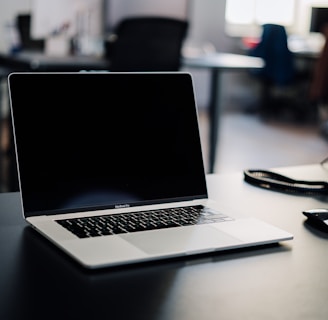 macbook pro on white table