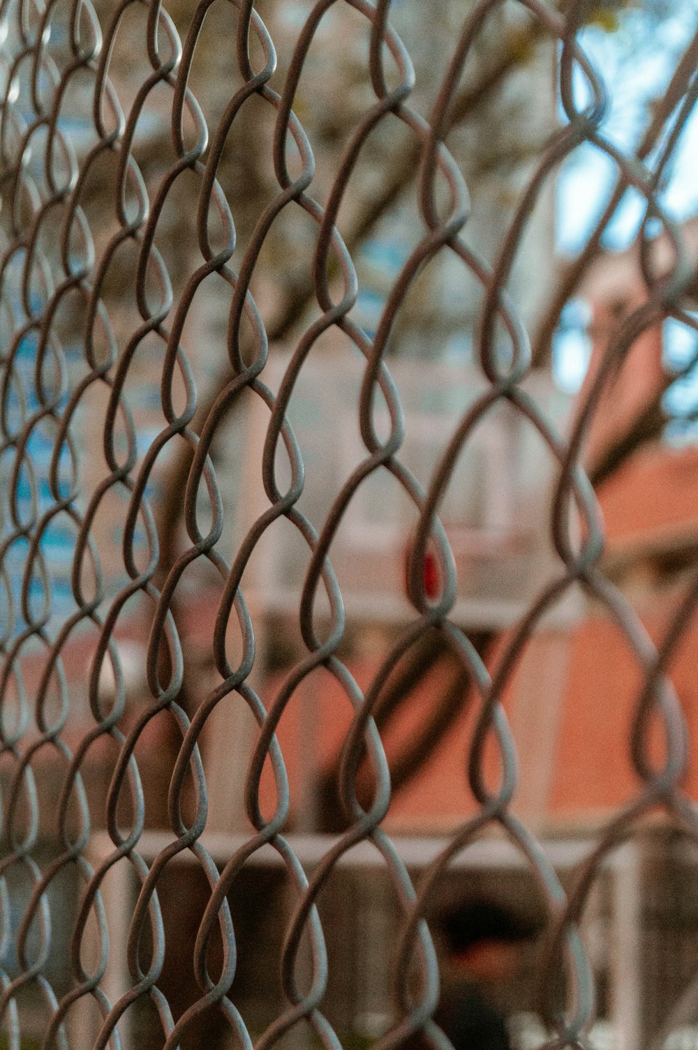 orange metal fence with chain link fence