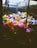 A collection of colorful stuffed animals inside a claw machine, including a panda, monkeys, foxes, and various other plush toys. The machine's interior lighting highlights the vibrant hues of the toys, creating a playful and inviting atmosphere.