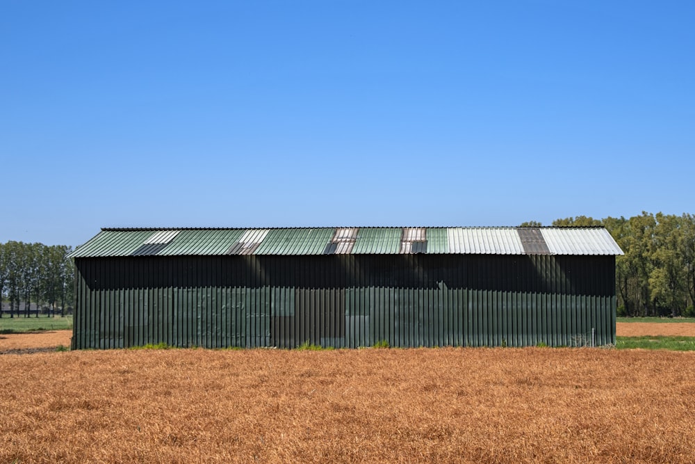 green and white metal building under blue sky during daytime