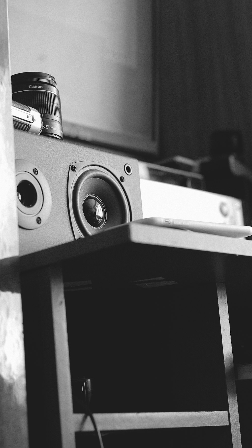 black and silver speaker on black wooden table