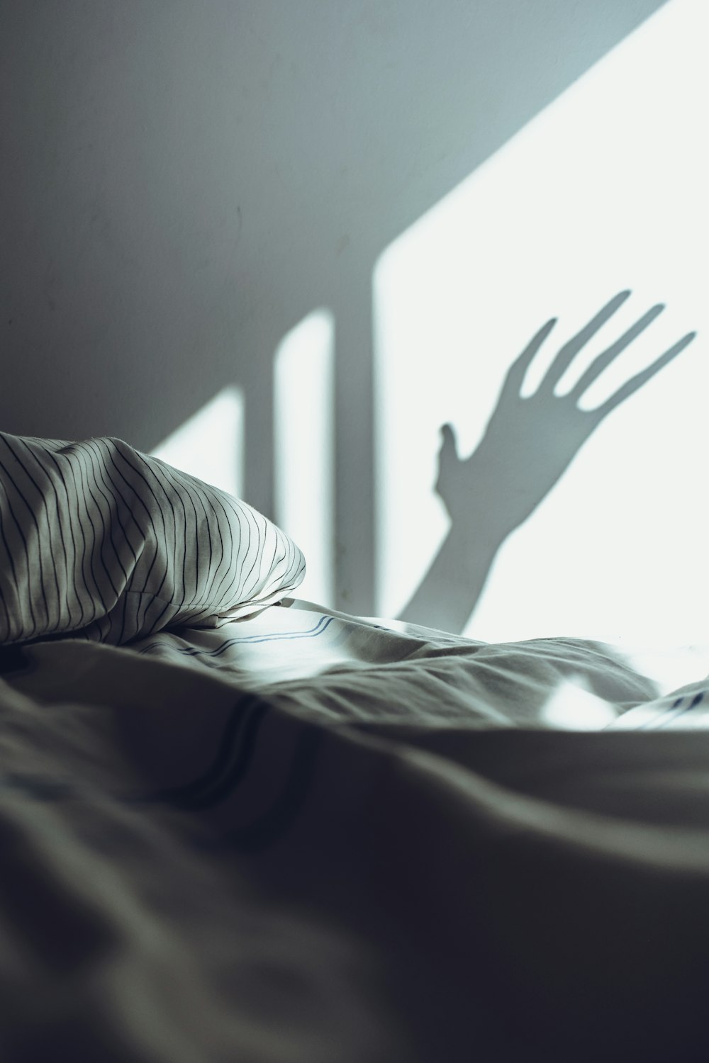 grayscale photo of person lying on bed