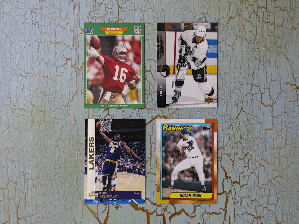 a group of four different sports cards hanging on a wall