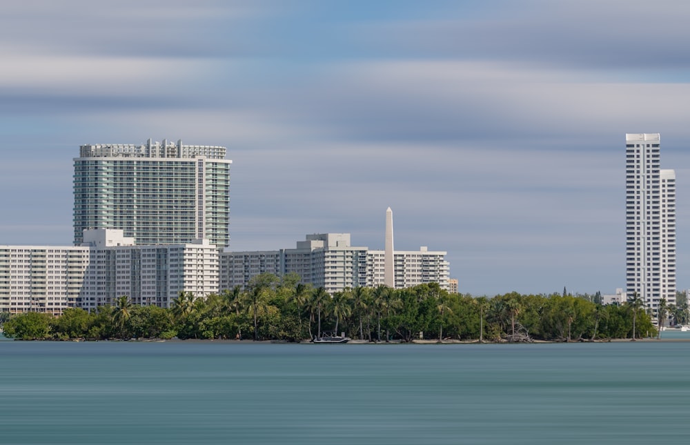 white high rise building near body of water during daytime