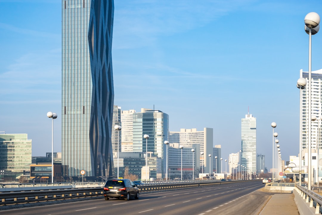 cars on road near city buildings during daytime