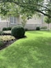A beautifully landscaped garden with vibrant flowers and well-maintained grass.
