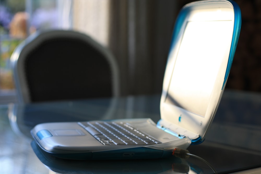 white laptop computer on table