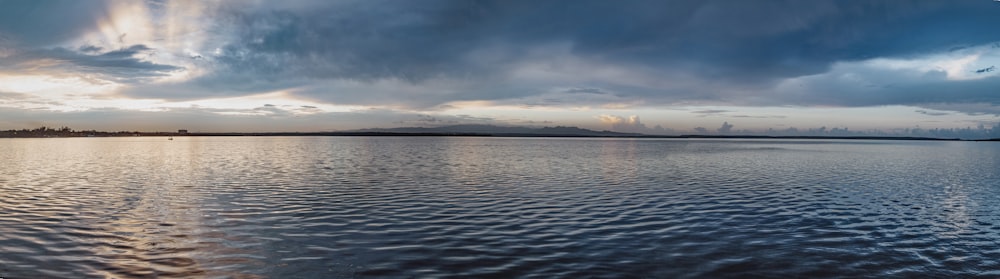 body of water under cloudy sky during daytime