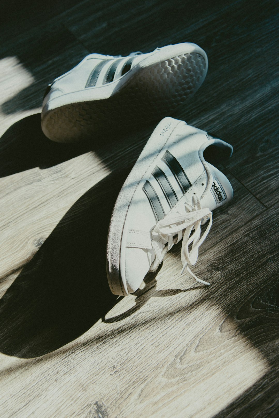 white and black adidas low top sneakers