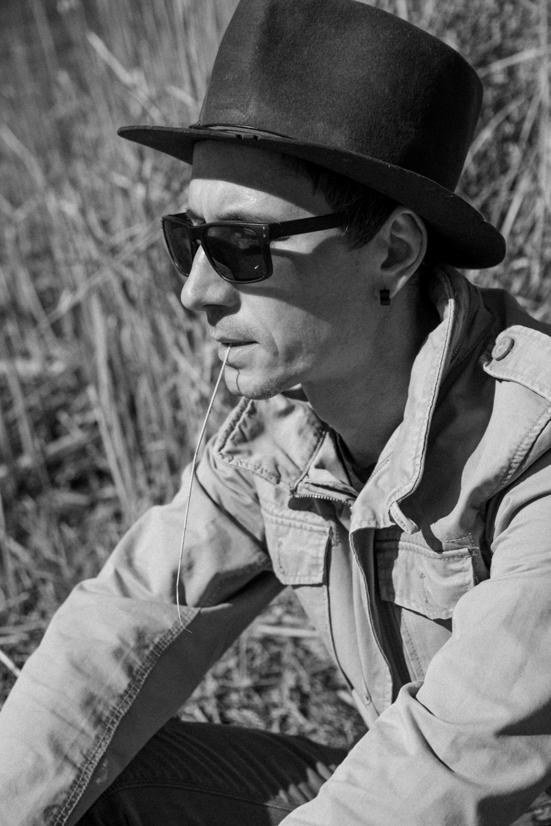 man in black sunglasses and hat