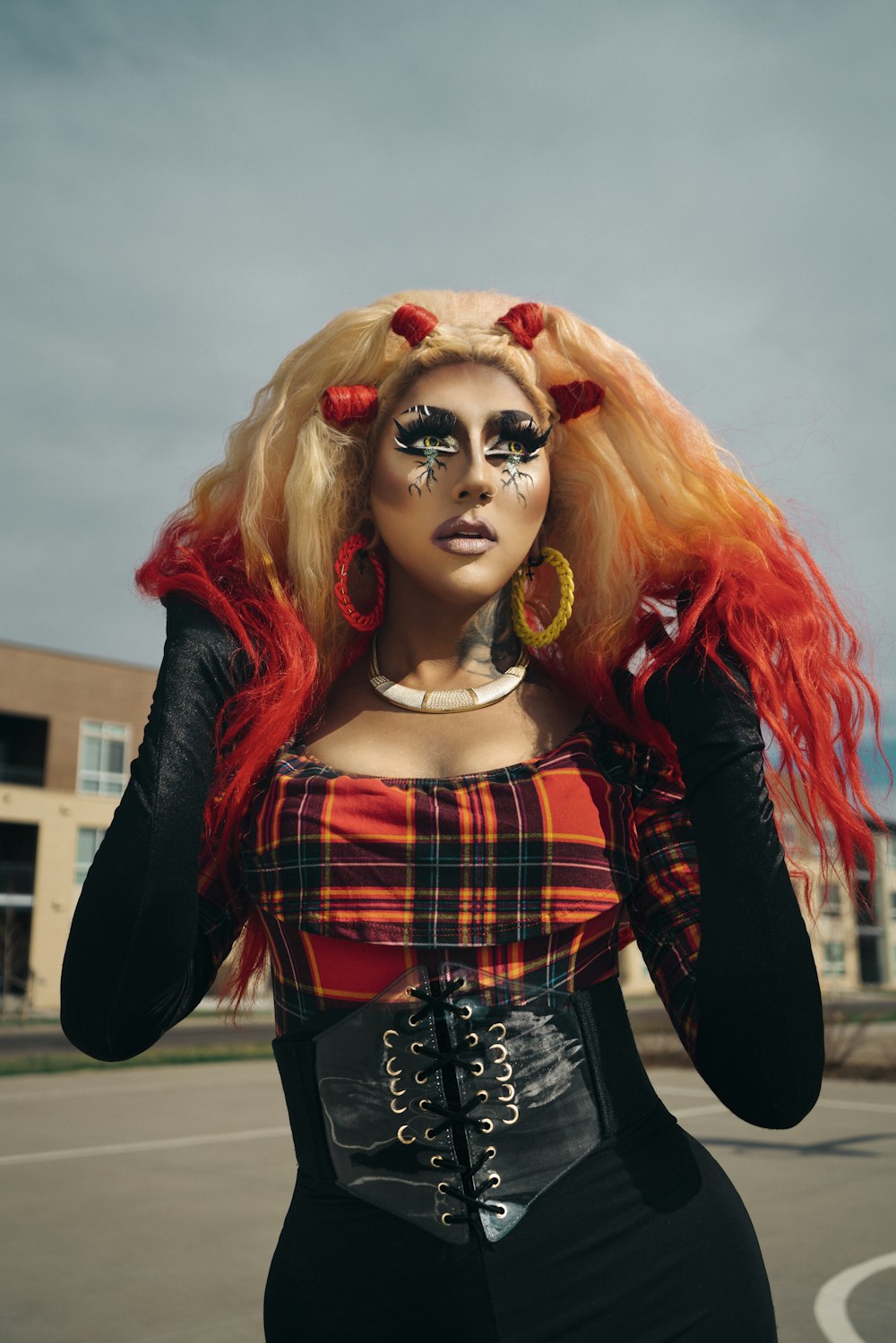 woman in red hair wearing black and red plaid dress shirt