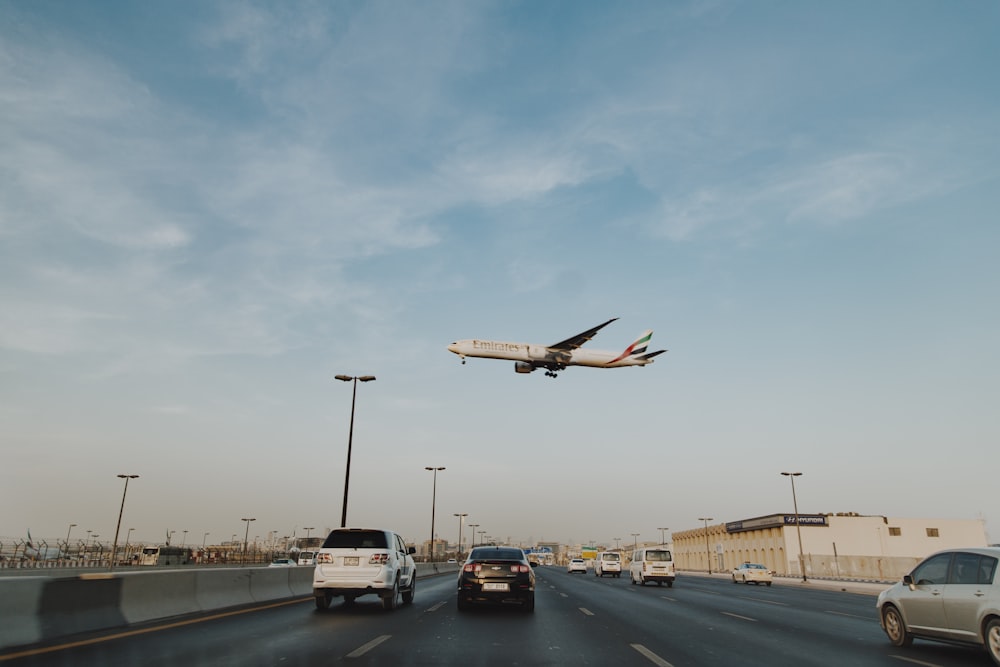 white and brown airplane on the city during daytime