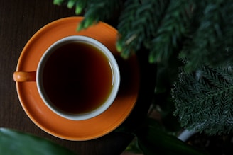 brown ceramic mug with brown liquid inside