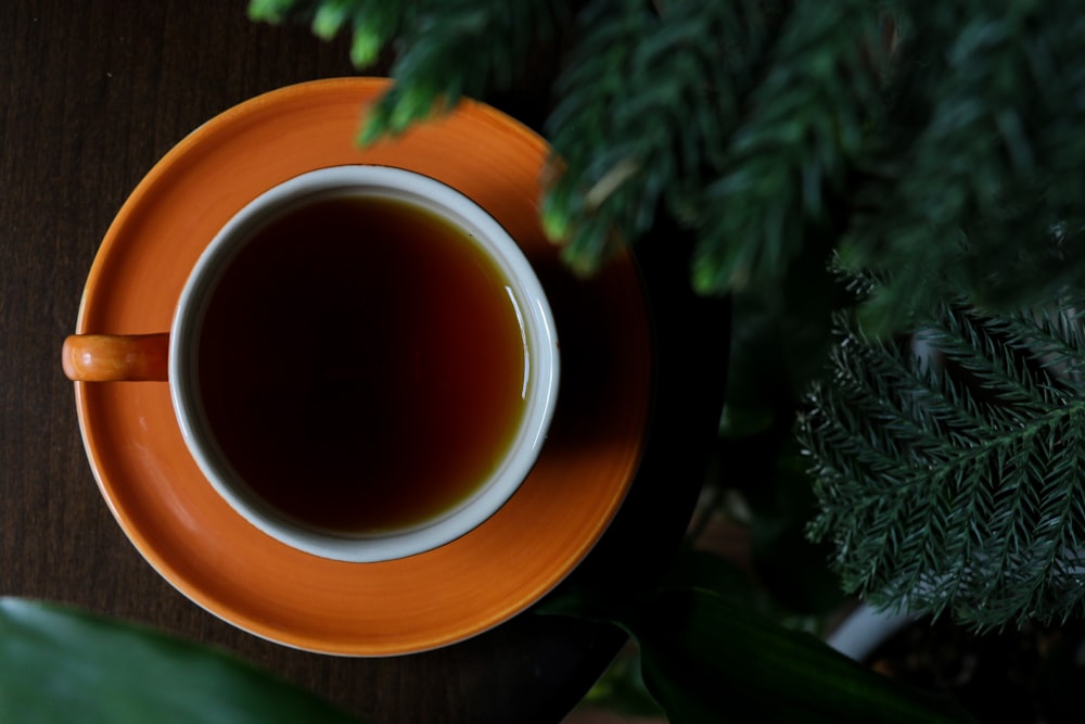 brown ceramic mug with brown liquid inside