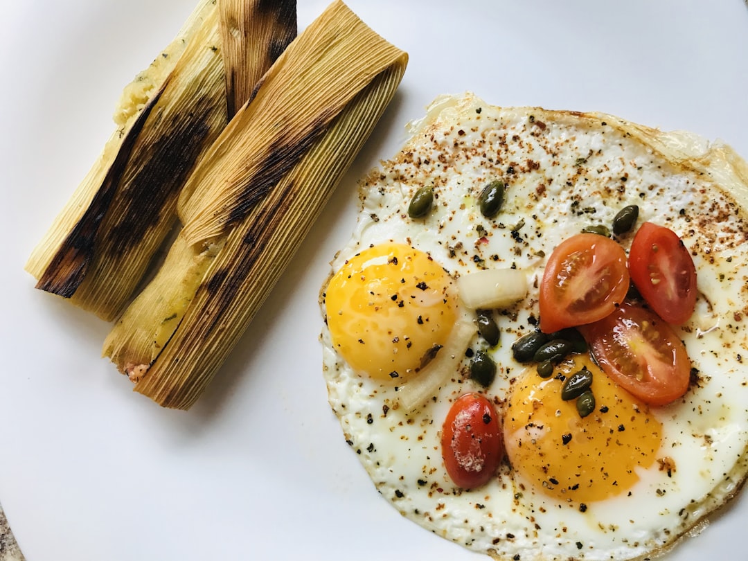 sliced bread with tomato and green vegetable on white ceramic plate, Desayuno Norteño