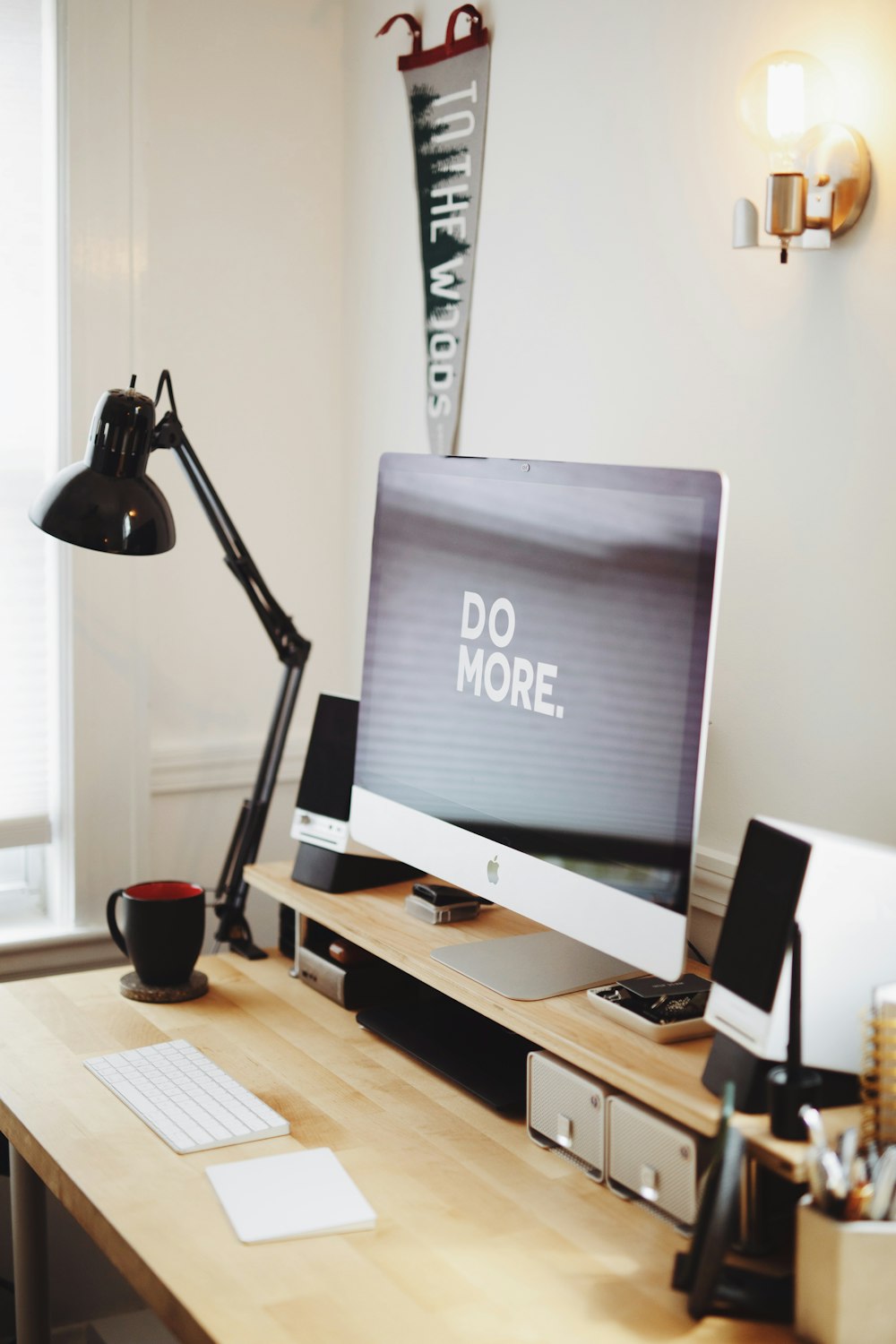 silver imac on brown wooden desk