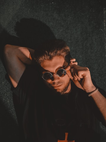man in black tank top wearing black sunglasses