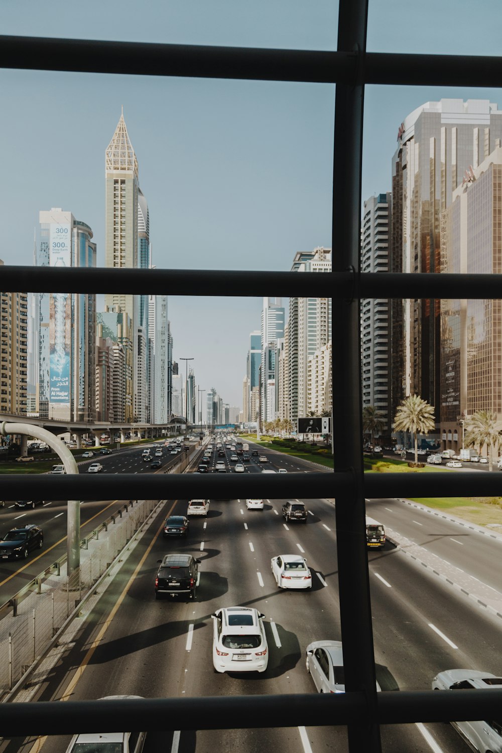 cars on road near high rise buildings during daytime