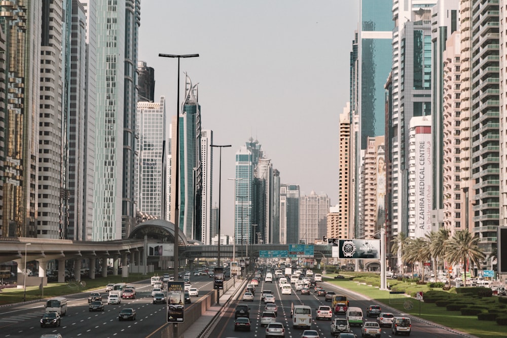 cars on road near high rise buildings during daytime